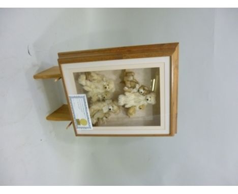 A FRAMED COLLECTION OF TEDDY BEARS "Box Your Bears", titled "On The Shelf" designed and made by Alison McGaham, signed and nu