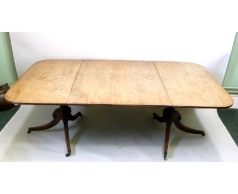 A 19TH CENTURY MAHOGANY TWIN PEDESTAL DINING TABLE, the rounded-off ends with moulded edge, raised on ring turned stems with 