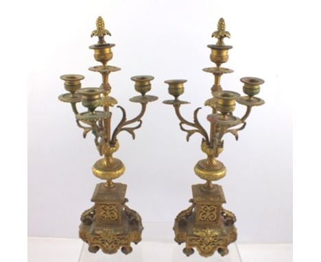 A PAIR OF LATE 19TH CENTURY GILT BRASS GARNITURE CANDELABRA of triple branch, four-light design, the decorative bases with ac