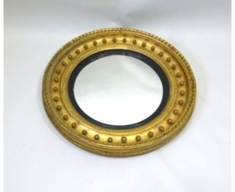 A PART 19TH CENTURY REGENCY STYLE GILT AND GOLD PAINTED CARTEL MIRROR, having bead and gadroon surround, reeded ebony filet a