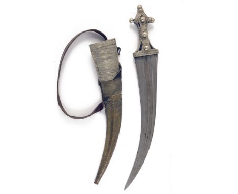 A LARGE WHITE-METAL MOUNTED KHANJAR DAGGER, South Arabia circa 1900, with 17in. curving double-edged blade with two shallow f