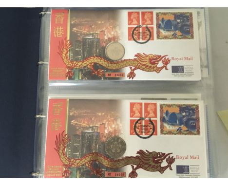 An Album containing a collection of Royal Mail Royal Mint Philatelic Numismatic Covers. in a blue album.