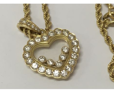 A Chopard Happy diamond 18ct yellow gold heart pendant,  the frame inset with five floating round cut brilliant diamonds with