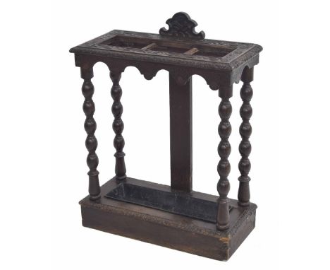 Carved oak umbrella/stick stand,&nbsp;raised on turned supports, 23.5" wide, 10.5" deep, 27" high 