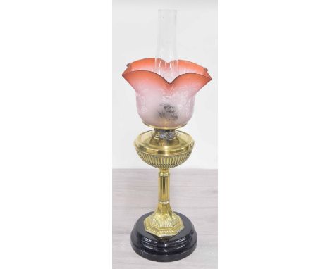 Victorian brass oil lamp, the reeded support and oil well mounted upon a pottery base, with etched rose glass shade, 24" high