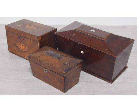 19th century mahogany rectangular tea caddy, the hinged cover with inlaid shell paterae enclosing two open compartments, the 