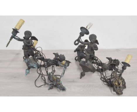 Pair of decorative metal three sconce ceiling candelabra light fittings, modelled with putti holding each fitting, 15" across