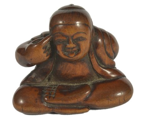 A JAPANESE WOOD NETSUKE OF A BOY DOING BEKKAKO, LATE EDO PERIOD, CIRCA 1860 seated with his tongue out and holding a mask beh