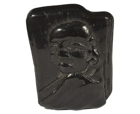 A JAPANESE UMOREGI NETSUKE, LATE EDO PERIOD, CIRCA 1860 carved in relief with Daruma, his fly whisk behind, signed on a metal