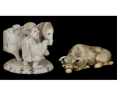 ˜A JAPANESE IVORY NETSUKE OF A RECUMBENT OX, EDO PERIOD, 18TH / 19TH CENTURY carved with a halter rope draped across its back