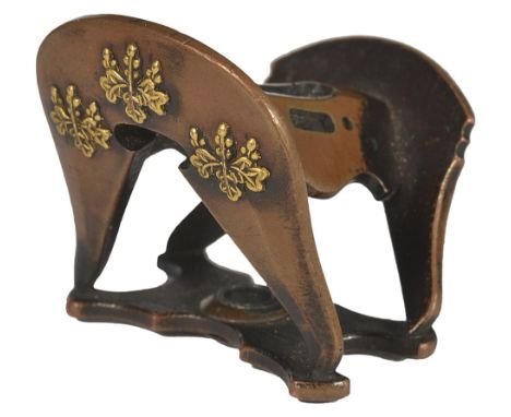 A JAPANESE COPPER NETSUKE OF A SADDLE, LATE EDO PERIOD, CIRCA 1860 with applied gilt kiri-mon, unsigned 2.9cm wide Provenance