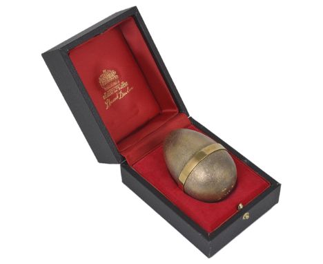 A SILVER-GILT 'SURPRISE' EGG, STUART DEVLIN, LONDON, 1981 the shell with lightly textured finish, opening to reveal a bee gat