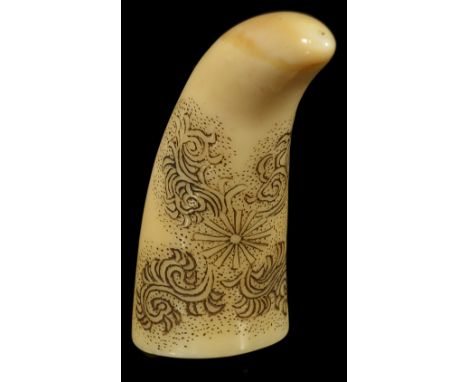 ˜A JAPANESE WHALE TOOTH NETSUKE, LATE EDO PERIOD, CIRCA 1860 engraved and inked with a design of karakusa around a stylized f