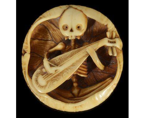 ˜A JAPANESE IVORY MANJU NETSUKE OF A SKELETON PLAYING A BIWA, EARLY MEIJI PERIOD, CIRCA 1870 seated within an enfolding lotus