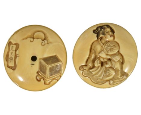 ˜A JAPANESE IVORY TWO-PART MANJU NETSUKE, MEIJI PERIOD (1868-1912) engraved with a geisha holding a fan, the reverse with a b