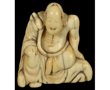 ˜A JAPANESE IVORY TOBORI NETSUKE OF A RAKAN, MID EDO PERIOD, CIRCA 1700 seated on a rock with gourds on his shoulders, unsign