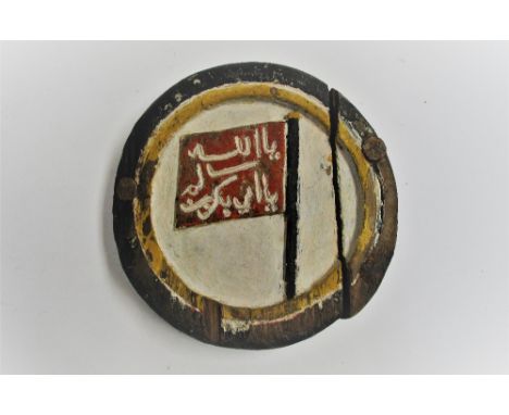 A NAME BADGE FROM A DHOW, PROBABLY LAMU, EAST AFRICA, FIRST HALF 20TH CENTURY carved and painted wood, of circular form, depi