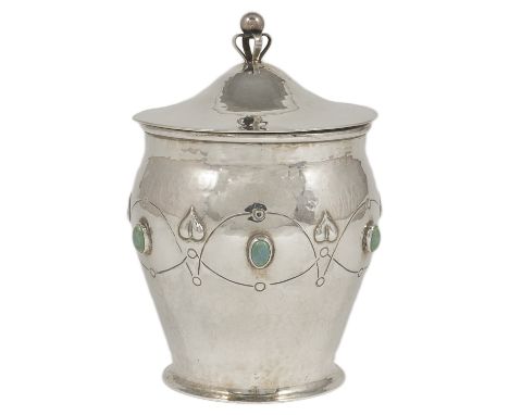 AN ARTS AND CRAFTS SILVER JAR AND COVER, A.E. JONES, BIRMINGHAM, 1908 the hammered ovoid body set with six Ruskin high-fired 