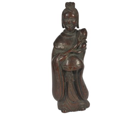 A JAPANESE WOOD NETSUKE OF SEIOBO, LATE EDO PERIOD, CIRCA 1850 holding a peach branch, with the fruit resting on her shoulder