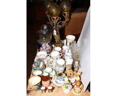 Crystal decanter, biscuit jar, cabinet cups and saucers, Hummel figures, Royal Doulton character jugs, table lamp, etc