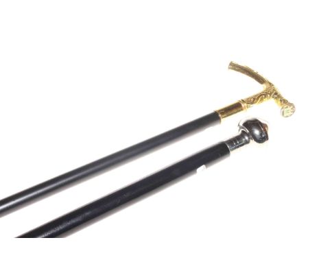 Ebonised walking cane with incorporated compass handle and ebonised walking stick with brass handle with armorial crest