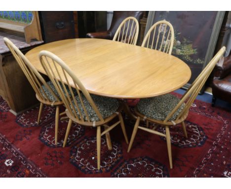 A light oak Ercol table and five chairs W.170cm fully extended
