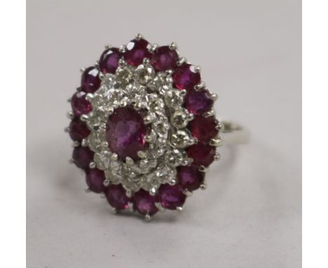 A white metal, ruby and diamond cluster dress ring, size L.