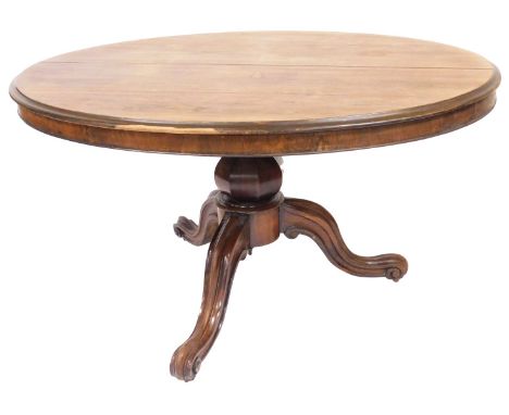 An early Victorian rosewood breakfast table, with moulded oval top, octagonal baluster pillar, on three carved and channelled