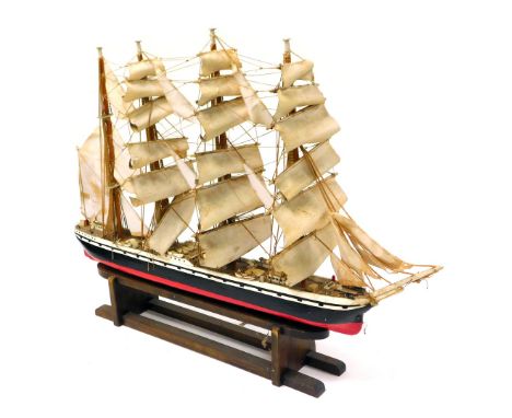 A wooden scale model of a clipper ship, fully rigged, with sails, on a wooden stand, 90cm wide.