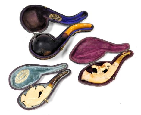 A late 19thC meerschaum pipe, carved and three chicks emerging from an egg in a clasped hand, cased, further meerschaum pipe 