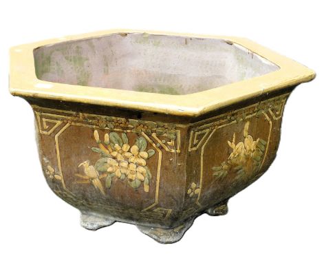A Chinese brown stoneware planter, of hexagonal form, decorated with panels of animals and birds, 77cm wide. 