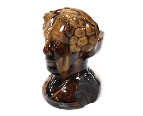 An early 19thC treacle glazed pottery sash window rest, modelled as a bust of a lady, 11cm high.