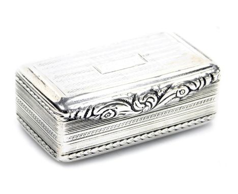 A George IV silver snuff box, the hinged lid with dedicated inscription and scroll swag thumb piece, engine turned decoration