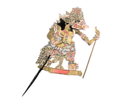 A vintage Wayang Kulit shadow puppet, with horn handle and stick operated articulated left hand, 87cm high.