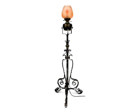 A Victorian duplex copper, brass and cast iron standard oil lamp, with a pink moulded glass floral shade, raised on a cylindr