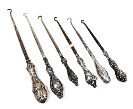 Six Victorian and later silver handled button hooks, with embossed decoration. 