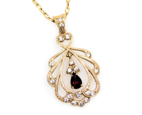 A 9ct gold ruby and diamond pendant in an Edwardian open work style, on a cable link neckchain, with bolt ring clasp, 5.8g.