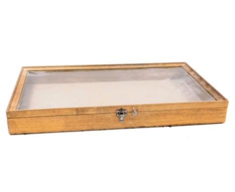 A light oak bijouterie cabinet, with a perspex set, hinged lid, width 61cm, depth 35.5cm.