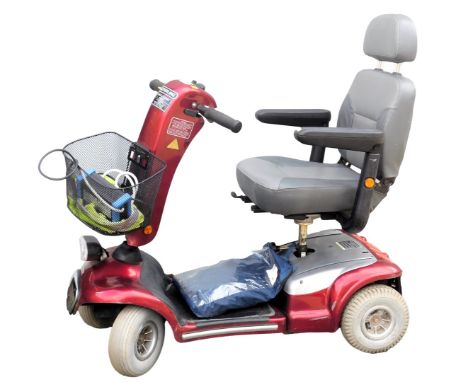 A Sterling Sapphire mobility scooter, red chassis, with battery and key.