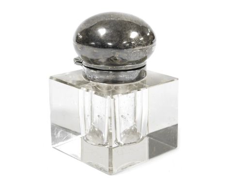 An early 20thC cut glass inkwell, of cube form, with a silver mount and hinged lid, bears indistinct hallmarks, 4.5cm wide. 