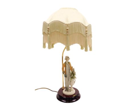 A late 20thC Florence figural table lamp, modelled by Giuseppe Armani, of a lady with a vase of flowers, serial number 0498CB