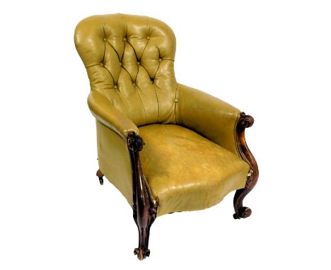A Victorian rosewood, button spoon back nursing chair, upholstered in tan leather fabric, raised on leaf carved cabriole legs