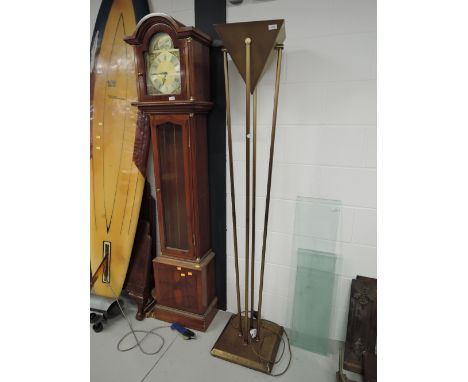 A vintage style brass uplighter with an Art Deco design