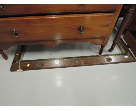 A vintage oak and brass fire fender