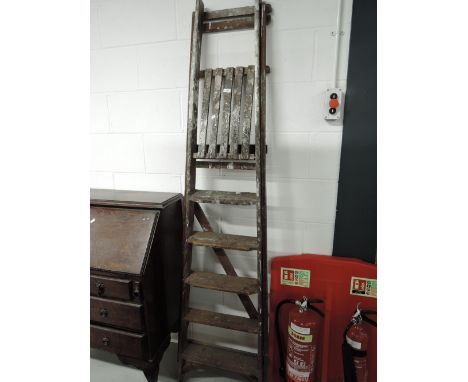 A pair of vintage wooden step ladders