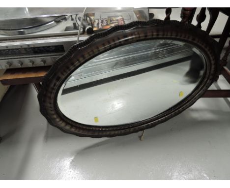 a vintage hallway mirror with turtle shell effect frame