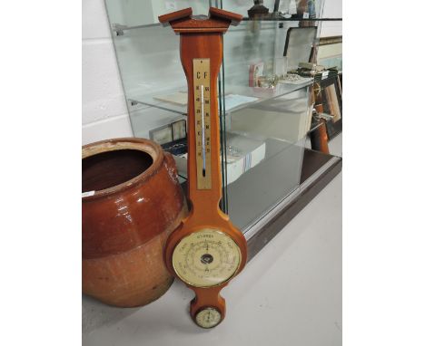 A vintage wall mounted barometer