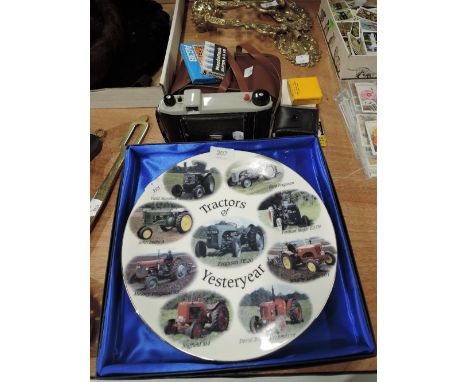 A selection of vintage curios and trinkets including tractor plate