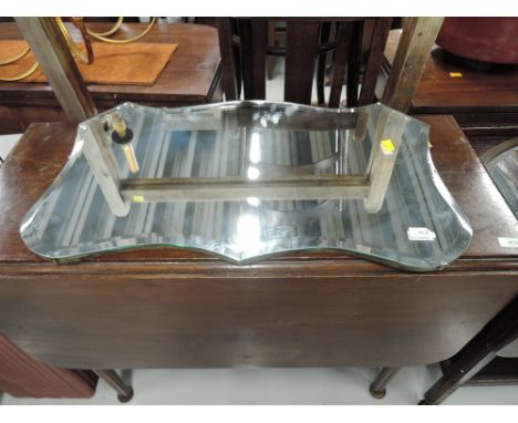 A vintage frameless wall mirror
