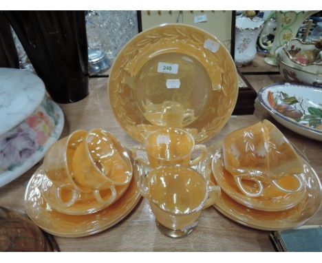 A part tea service in peach colour pressed glass